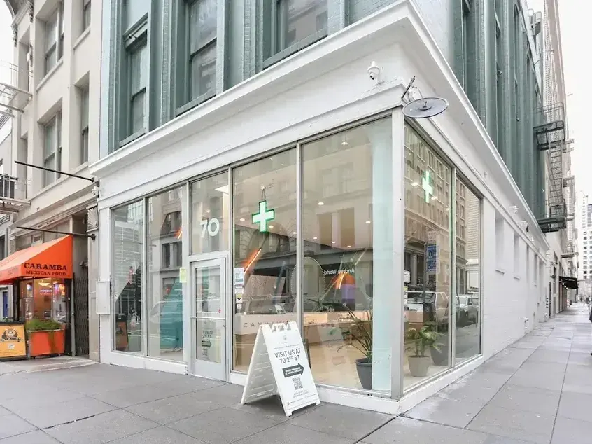 Cannavine dispensary exterior with glass windows and sidewalk sign in San Francisco