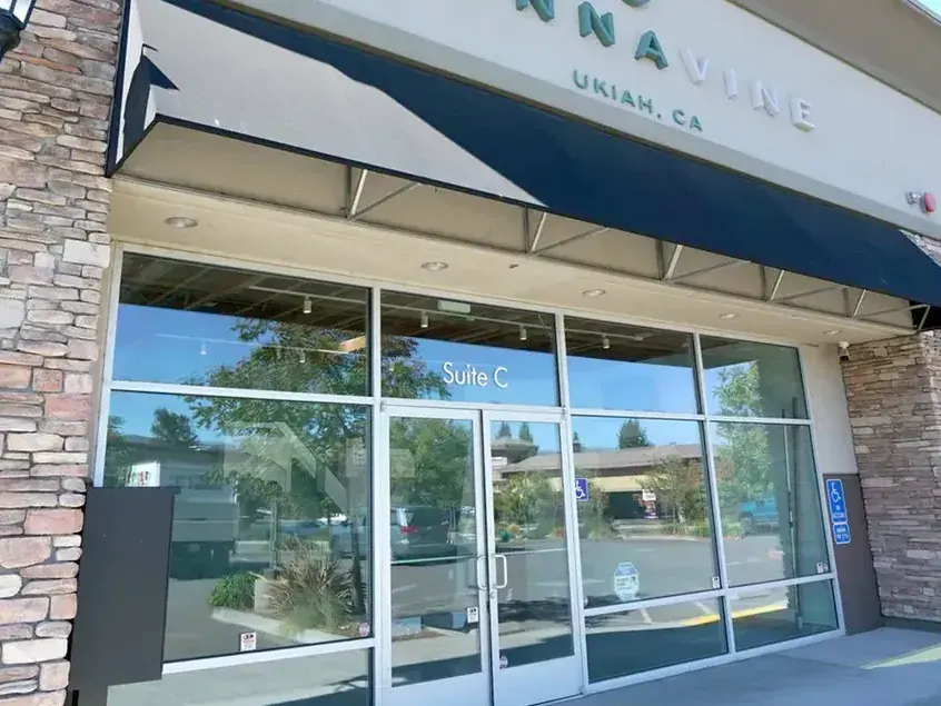 Cannavine Ukiah CA storefront with blue awning and stone pillars